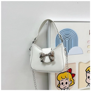 Close-up of white crescent PU leather bag with silver metal bow and chain strap