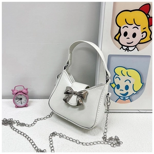Detailed macro view of the silver bow metal buckle and chain on the white PU leather bag