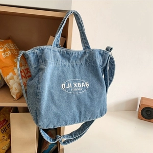 Minimalist light blue denim tote bag with embroidery logo and adjustable strap