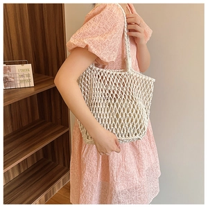 Detail of white woven cotton mesh tote bag featuring a practical inner fabric lining