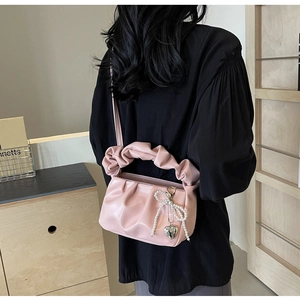 Pink cloud-shaped PU leather handbag featuring a pearl bow and heart metal pendant charm