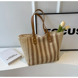 Fashionable large straw tote bag with vertical brown stripes and leather handles