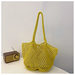 Handcrafted yellow woven tote bag with white inner pouch and braided handles in French style