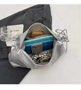 Top view of spacious silver PU leather handbag showing storage for tablet, phone, and umbrella
