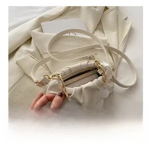 Top view of white pleated cloud bag showing interior capacity and magnetic closure