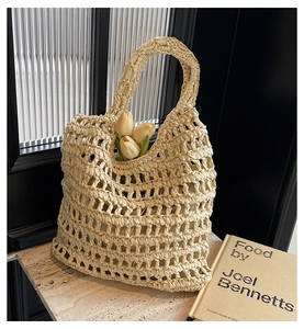 Detailed macro view of cream hollow straw woven handbag with rustic mesh texture and handle