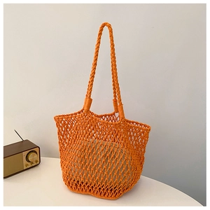 Handmade orange macrame tote bag with cotton liner and woven handle for summer beach style