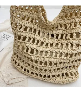 Detailed macro view of woven hollow straw texture and matching fabric lining on the handbag