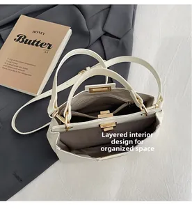 Detail view of structured handbag showing organized interior multi-layer compartment design