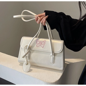 Detail of a creamy white PU leather handbag featuring elegant pink butterfly embroidery