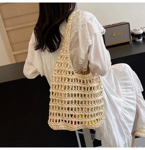 Close-up of beige crochet woven shoulder bag with intricate mesh pattern and soft texture