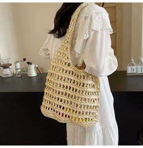 Close-up of beige crochet woven tote bag featuring large mesh design and long shoulder strap