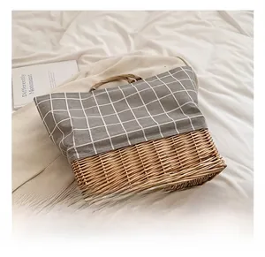 Detailed view of woven straw base and grey checkered fabric on minimalist tote bag