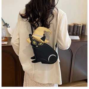 Detail of black cat PU crossbody bag with golden wizard hat and silver moon sequin detail