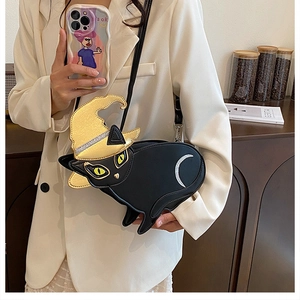 Detail of black cat shaped PU leather crossbody bag featuring gold wizard hat and moon decoration