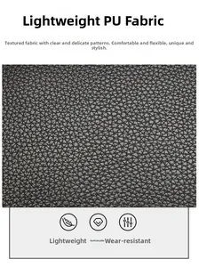 Close-up of premium black PU leather with litchi texture on a stylish handbag