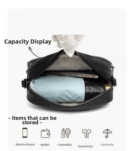 Internal storage view of black litchi pattern crossbody bag with multiple compartments
