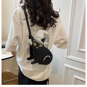 Detail of creative black cat crossbody bag with silver wizard hat and yellow cat eyes