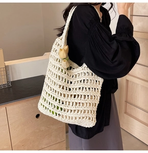 Detail of cream crochet shoulder bag featuring large hollow mesh and soft woven texture