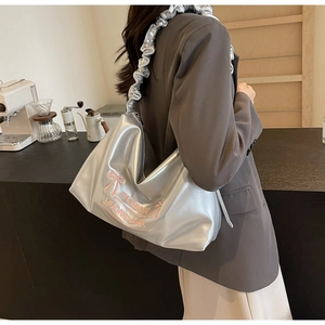 Silver metallic shoulder bag with pink bow embroidery and stylish ruffled strap detail
