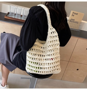 Detail of a minimalist off-white woven rope mesh shoulder bag showing its capacity