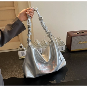 Detailed view of silver cloud bag with pink bow embroidery and pleated handle design