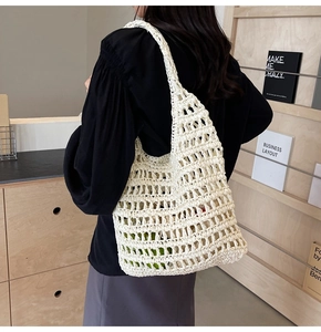 Detailed view of a white crochet hobo bag showing woven mesh texture and slouchy crescent shape