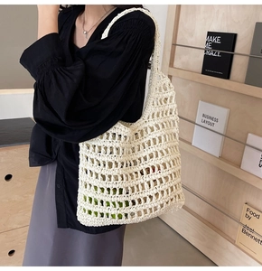 Detail of hand-woven beige mesh straw bag showing intricate hollow texture and load capacity