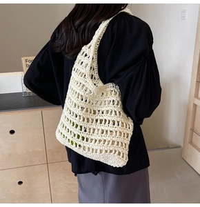 Detail of hand-woven beige crochet tote bag showing durable texture and large capacity