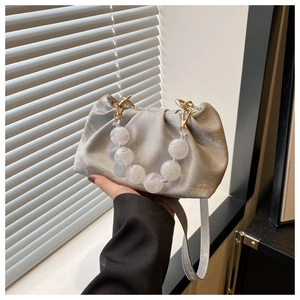 Silver metallic pleated cloud handbag with marble bead handle and adjustable strap