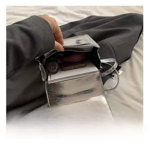 Top-down detail of PU leather backpack interior showing capacity for phone and notebook