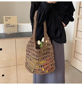 Detail of hollow woven tote bag in coffee brown showing large mesh pattern and texture
