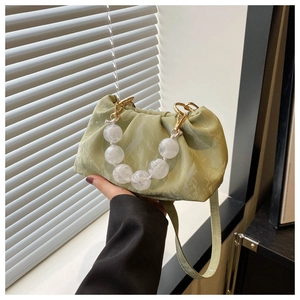 Light green marble pattern pleated handbag with large beaded handle and gold metal buckle