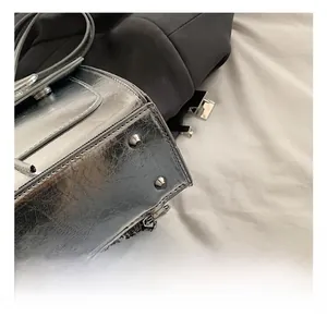 Detail shot of the reinforced silver bag base with cone-shaped metal rivets