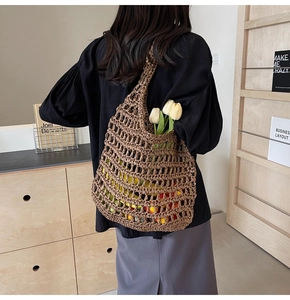Detailed view of handmade brown crochet mesh tote bag featuring a hollow-out woven texture