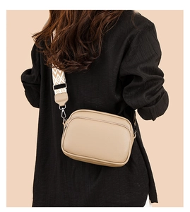 Detail of khaki PU leather crossbody bag with wide geometric pattern jacquard strap