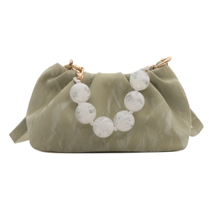 Sage green cloud bag with marble bead handle and golden hardware on white background