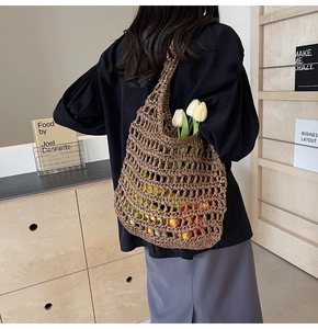 Detail shot of brown hand-woven hollow net bag with bohemian grid pattern and tulips