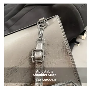Detail of adjustable shoulder strap with silver metal buckle and lobster clasp on PU backpack