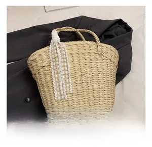 Detailed texture of natural beige straw tote bag with elegant white lace ribbon decoration