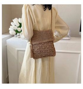 Detailed woven crossbody bag with hollow patterns, fringe tassel and wooden beads