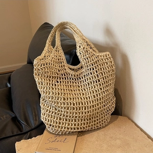 Minimalist straw woven tote bag with hollow knit design for summer beach and vacation