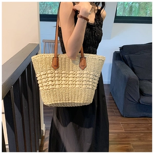 Vue détaillée du sac cabas en paille tissée avec maille ajourée et anses en cuir