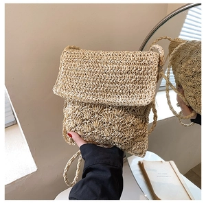 Minimalist straw woven crossbody bag in natural beige with textured woven pattern and flap