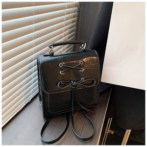 Minimalist black PU leather mini backpack with lace-up bow design for women's spring fashion