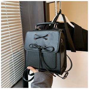 Minimalist black PU leather backpack for women with lace-up bow and crinkle texture
