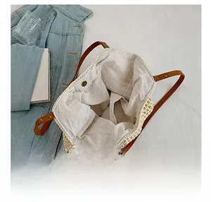 Detail view showing large capacity and inner pocket of off-white knitted tote bag