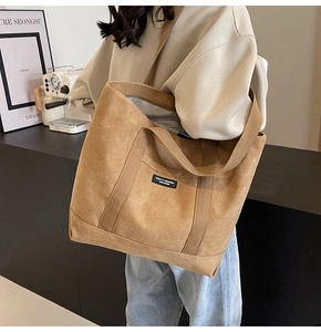 Detail of high-density canvas tote bag with MODO brand tag and durable shoulder straps