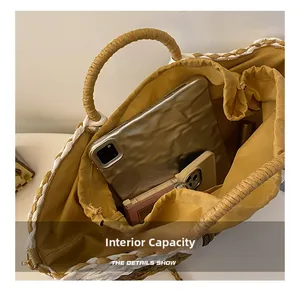 Detailed view showing large internal capacity of the straw tote bag with yellow lining