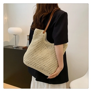 Detail of hand-woven hollow knit shoulder bag with premium brown leather strap